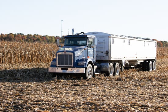 A semi-truck hauling grain during harvest, signaling time to plan ag financing for the year ahead.